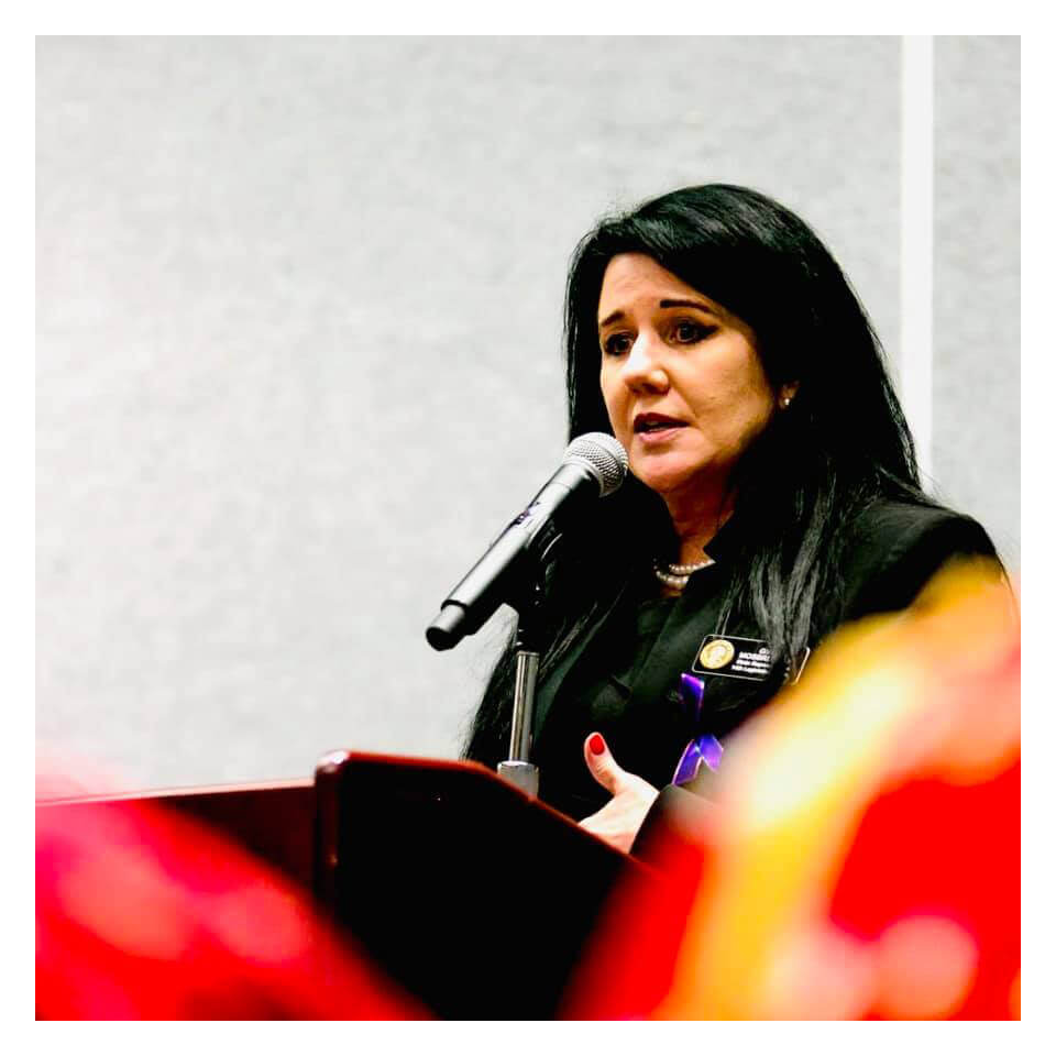 Gina Mosbrucker speaking at a podium