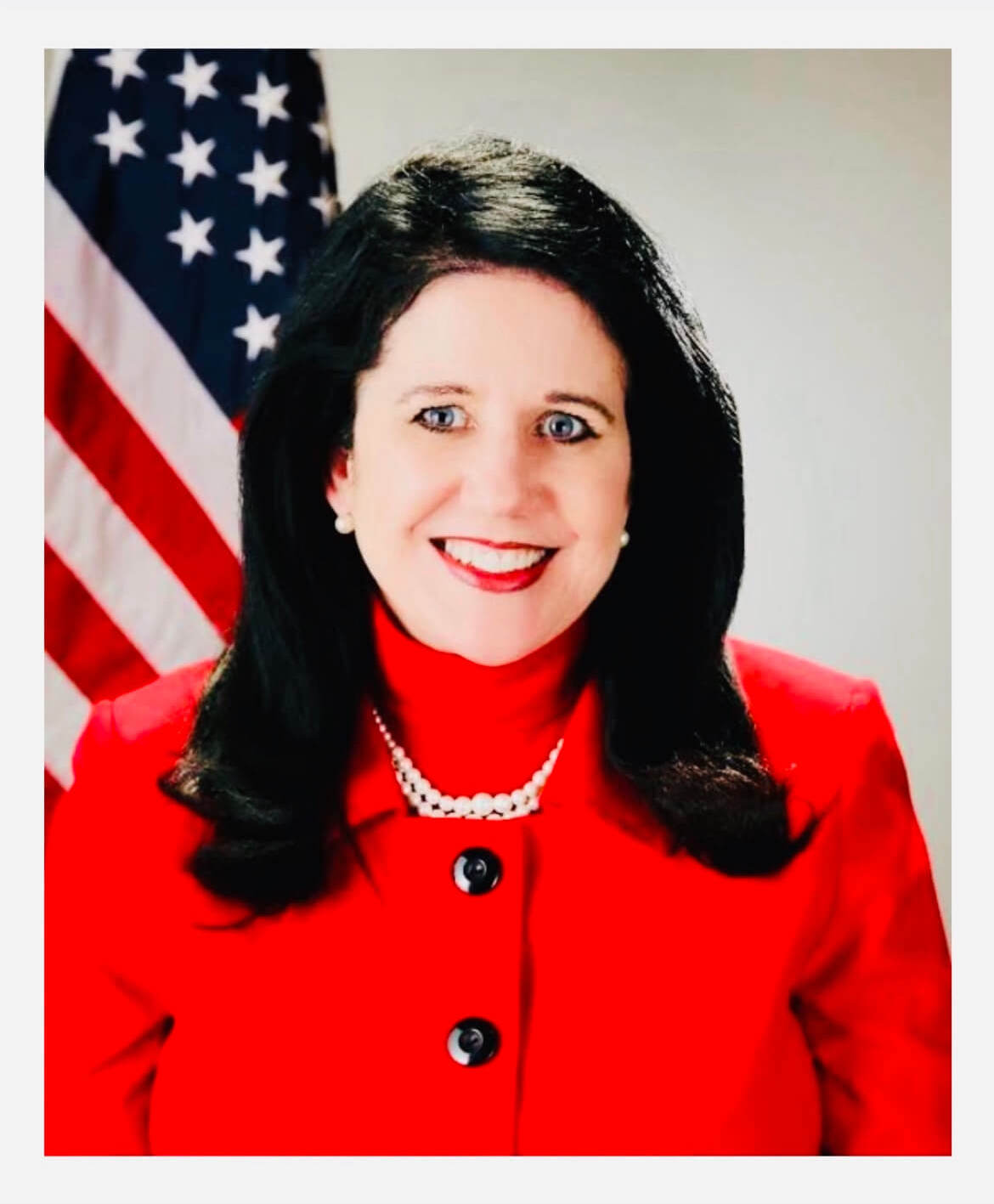 Gina Mosbrucker posing with American flag in the background